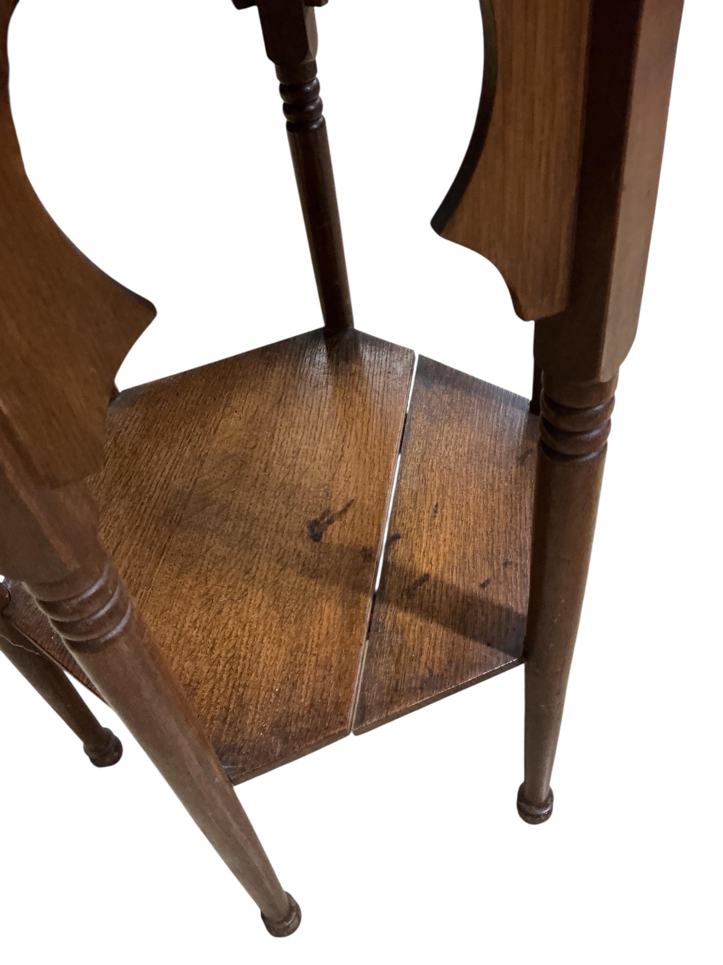 A pair of early 20th century Liberty style hexagonal oak two tier occasional tables, width 48cm, height 71cm